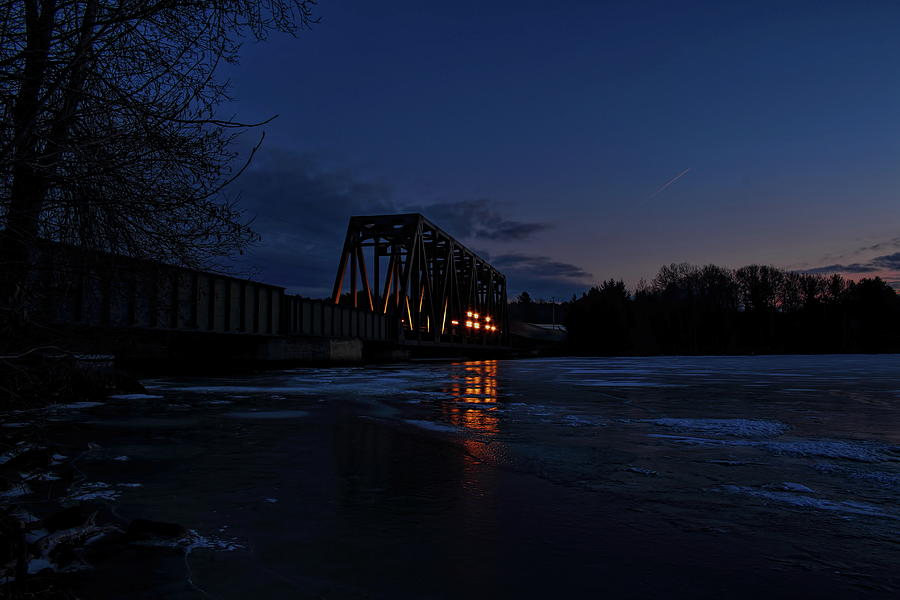 Sunset Train Over Icy Crossing Photograph by Dale Kauzlaric