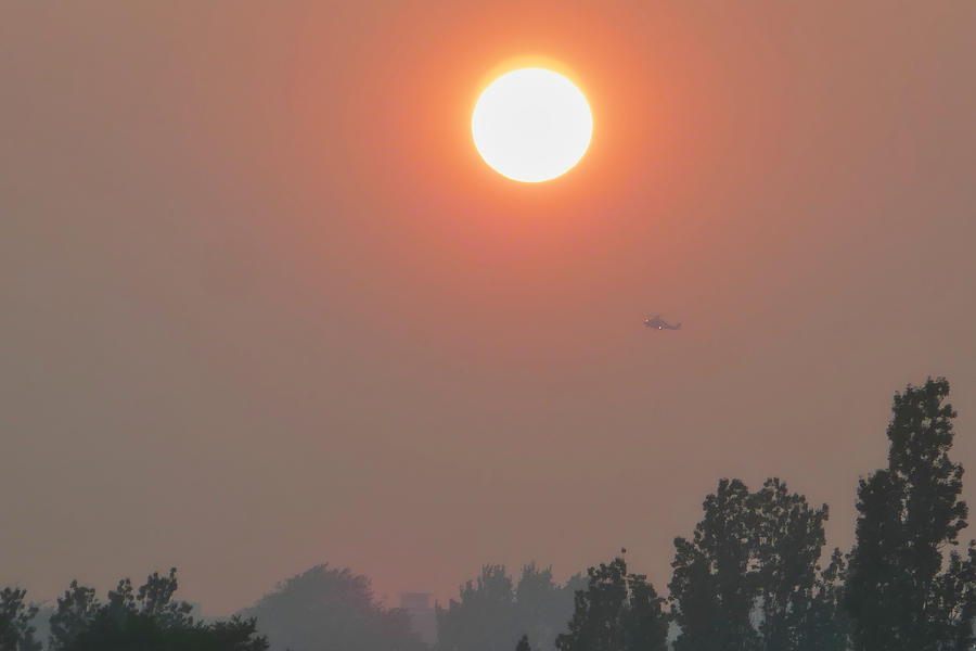 Sunset under smoky sky due to BC forest wildfire, in Vancouver BC Canada. Photograph by Totororo