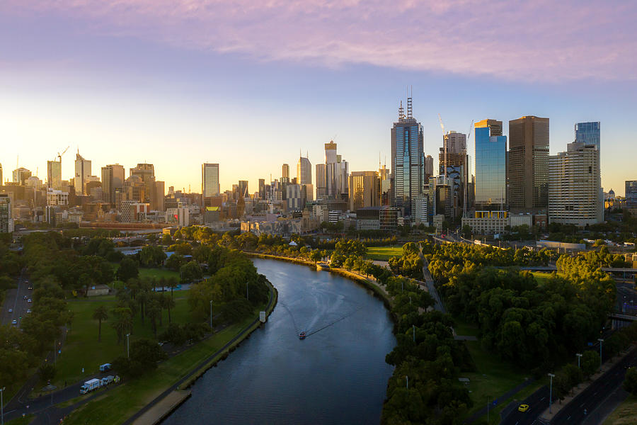 Sunset view of Yarra river and Melbourne skyscrapers business office building with evening skyline in Victoria, Australia. Australia tourism, modern city life, or business finance and economy concept Photograph by Prasit photo