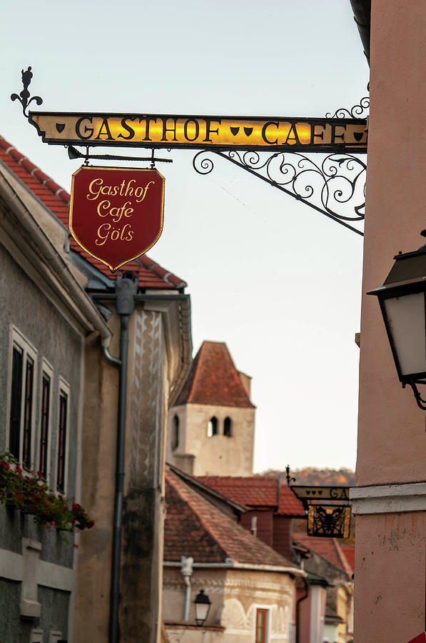 Sunset Walks In Durnstein. Main Street and Forged Signs 1 Photograph by Jenny Rainbow