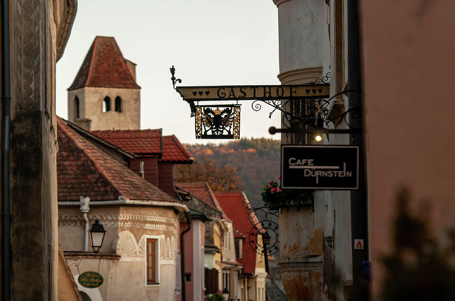 Sunset Walks In Durnstein. Main Street And Forged Signs 2 Photograph by Jenny Rainbow