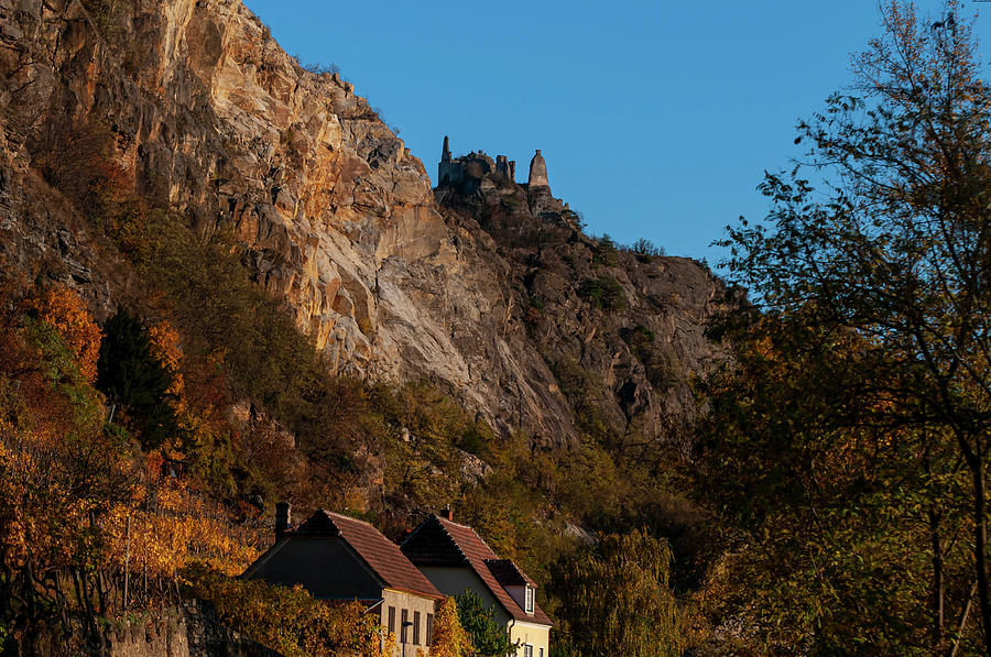 Sunset Walks In Durnstein. Rocks and Houses Photograph by Jenny Rainbow