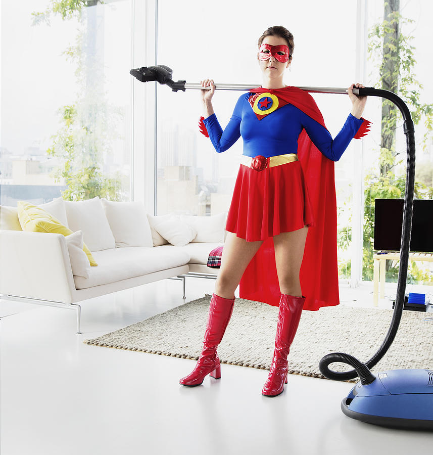 Superhero holding vacuum in living room Photograph by Robert Daly