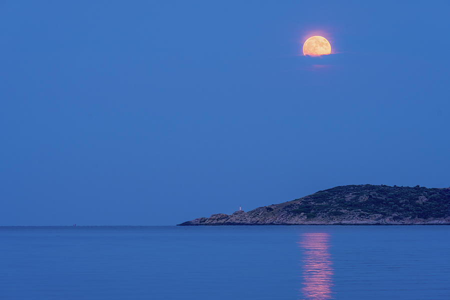Supermoon Rising Behind Clouds Above The Sea Photograph
