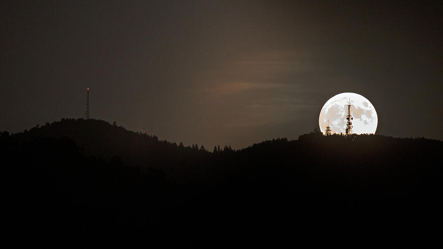 Supermoon rising behind Mount Krim Photograph by Ian Middleton