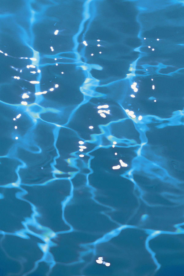 Surface of water in swimming pool Photograph by Comstock