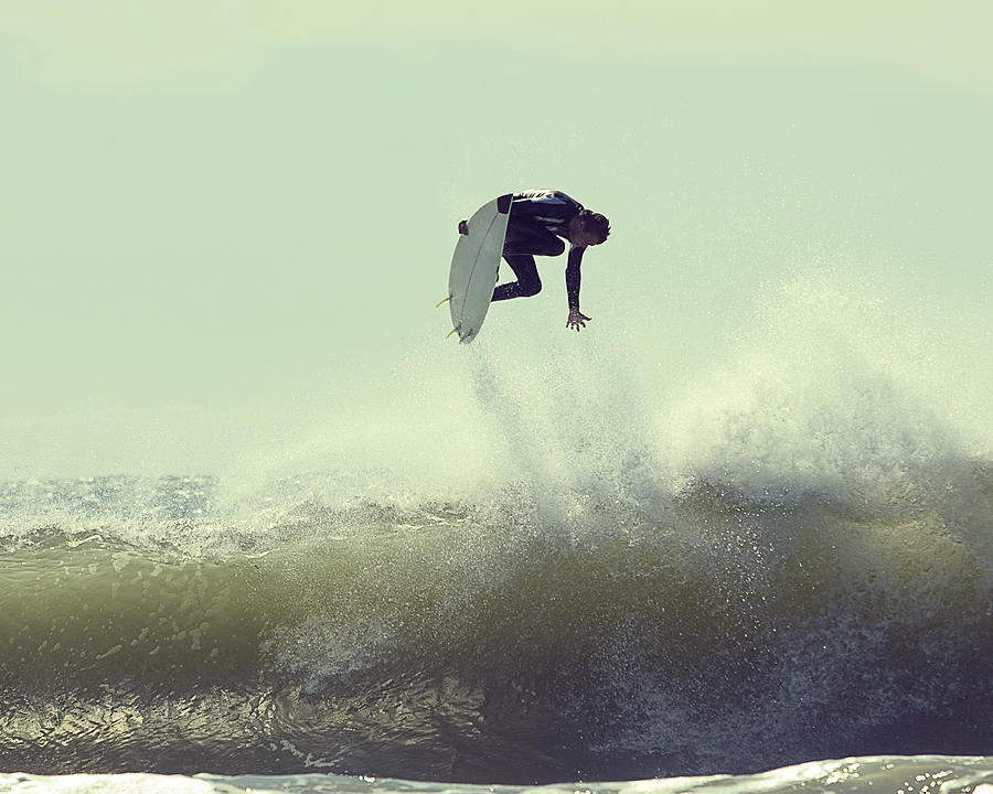 Surfer in mid-air Photograph by Chad Riley