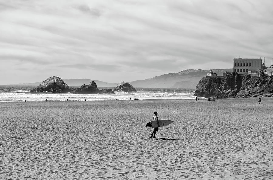 Surfer on Ocean Beach out to Seal Rocks and Camera Obscura San Francisco Black and White Photograph by Shawn OBrien