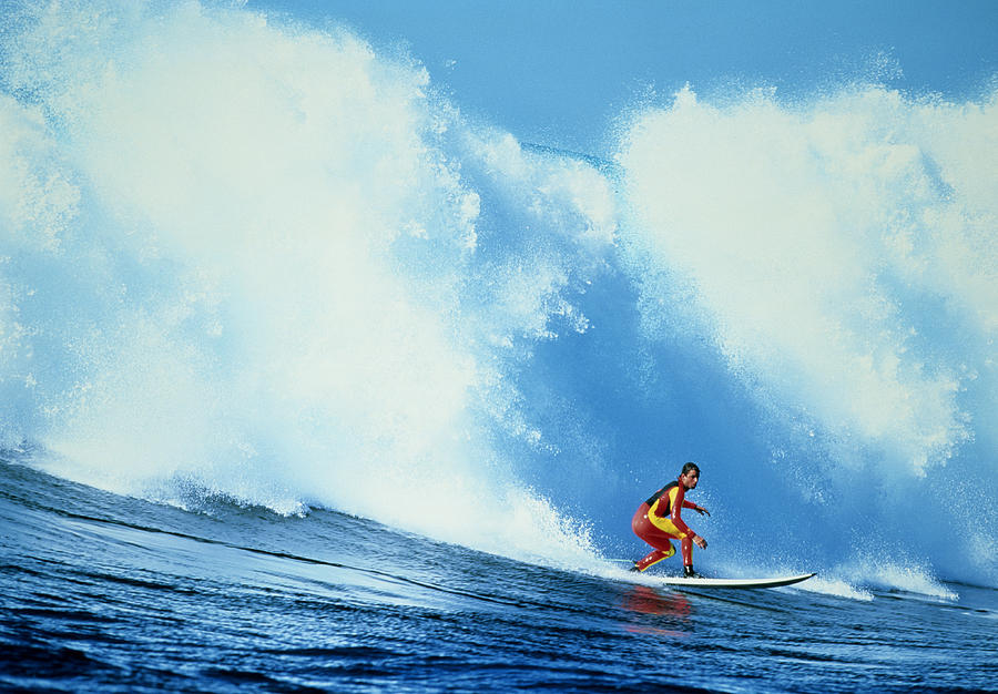 Surfer riding large wave Photograph by Getty Images