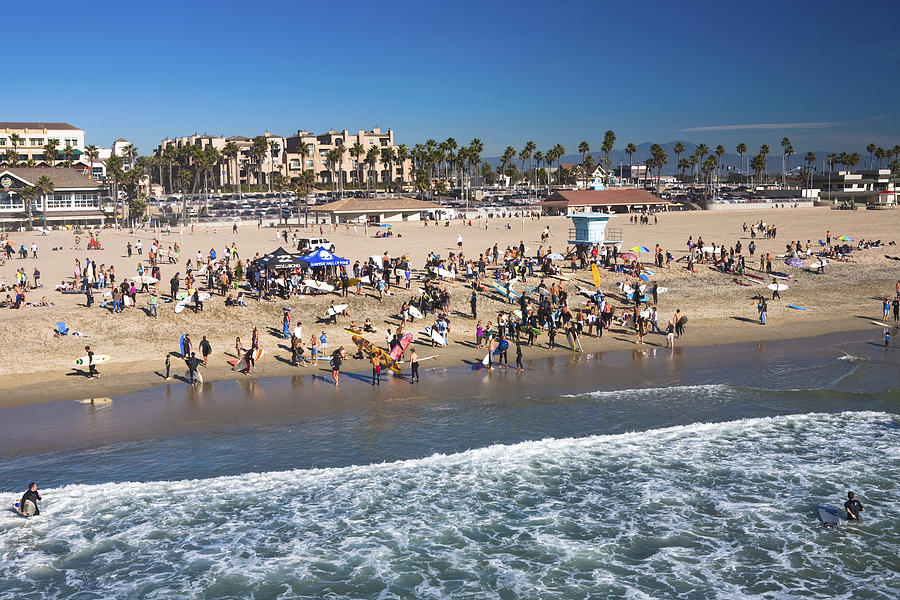 Surfers at memorial paddle out commemorating pro surfer Andy Irons by Huntington Beach Pier. Photograph by Matthew Micah Wright