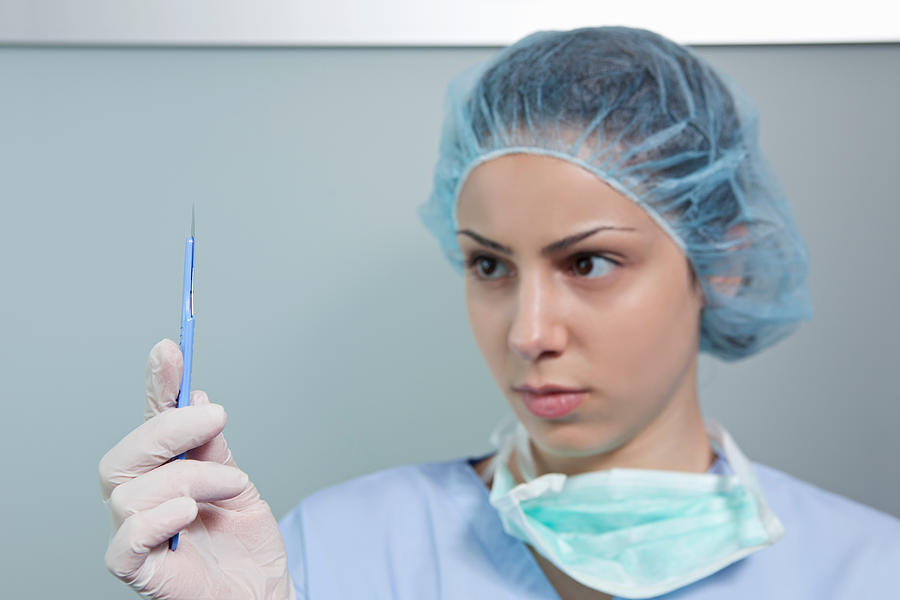 Surgeon holding scalpel Photograph by Image Source