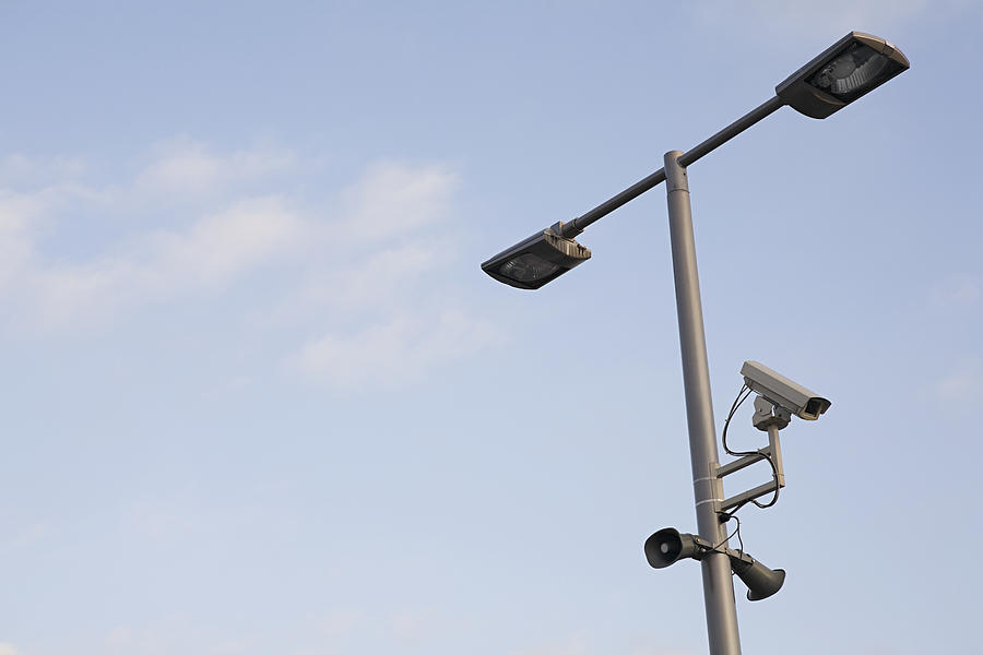 Surveillance camera on a lamppost Photograph by Image Source