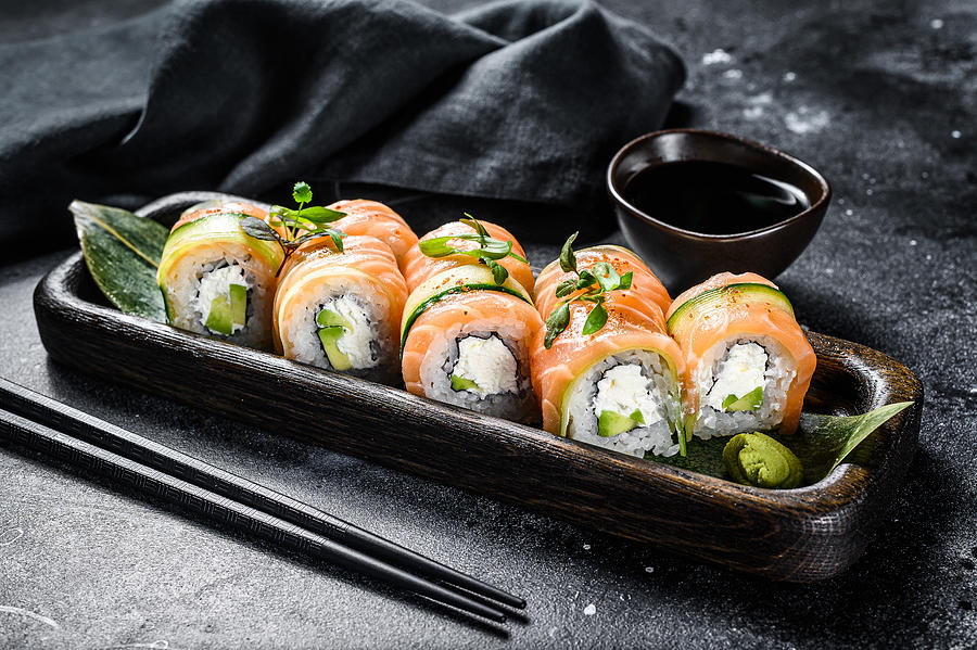 Sushi roll Philadelphia with salmon, avocado, cream cheese. Sushi menu. Japanese food. Black background. Top view Photograph by Vladimir Mironov