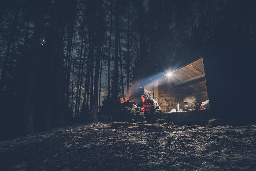 Sweden, Sodermanland, man at shelter with campfire at night Photograph by Westend61