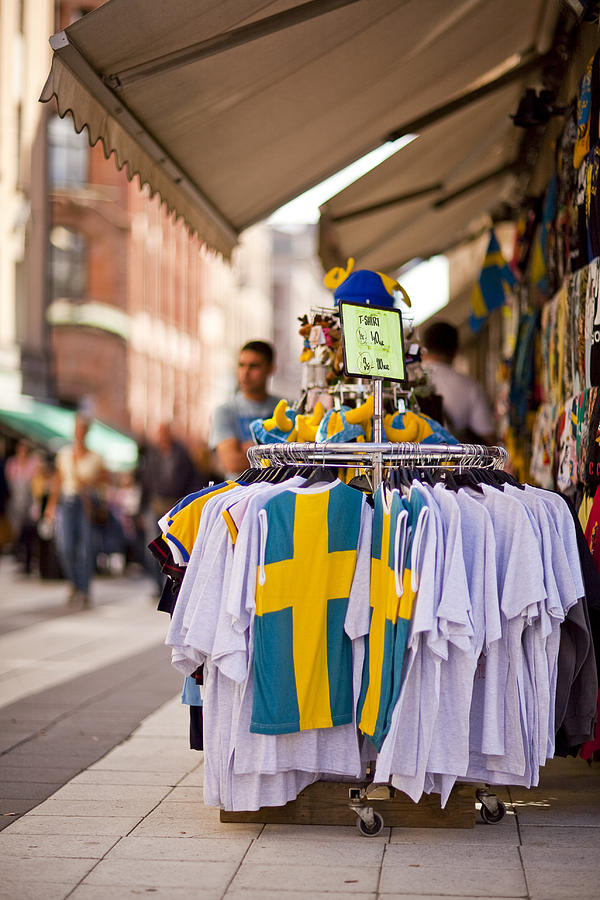 Swedish-themed tourist shop on Drottninggatan with national flag shirts on display. Photograph by Merten Snijders
