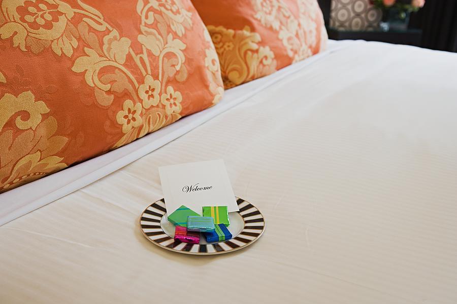Sweets on a hotel bed Photograph by Image Source