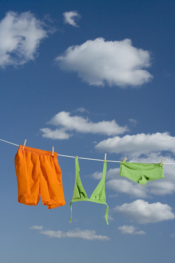Swimsuit hanging on clothesline Photograph by Comstock Images