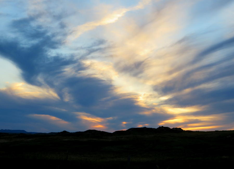 Swirling clouds at Sunset Photograph by Katie Keenan