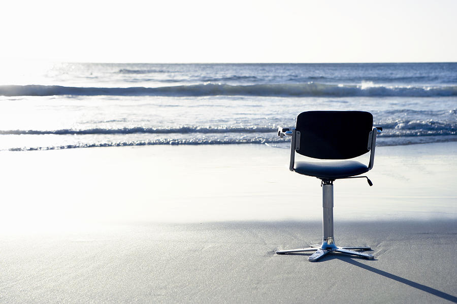 Swivel Chair on a Beach by the Sea Photograph by John Cumming