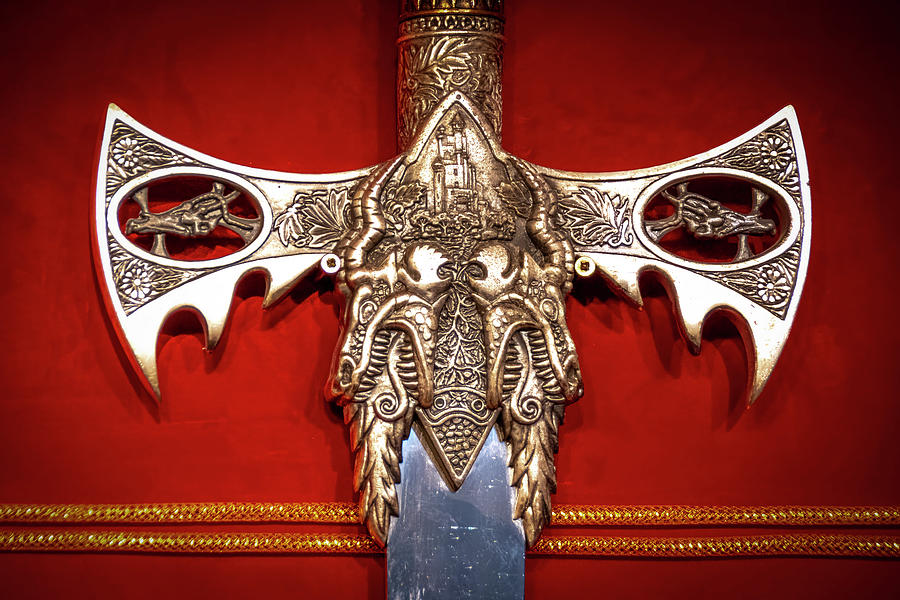 Fantasy Photograph - Sword Hilt and Guard Against a Red Background by John Twynam