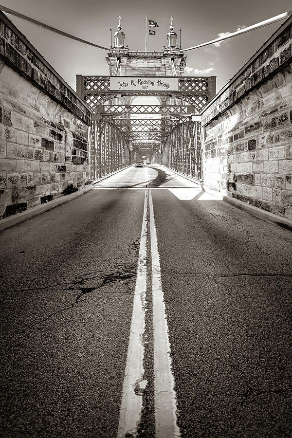 Symmetrical Cincinnati Passage - The John Roebling Bridge In Sepia Photograph by Gregory Ballos