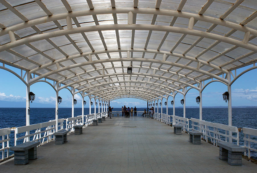 Symmetrical covered walkway by ocean Photograph by Photography by Jessie Reeder