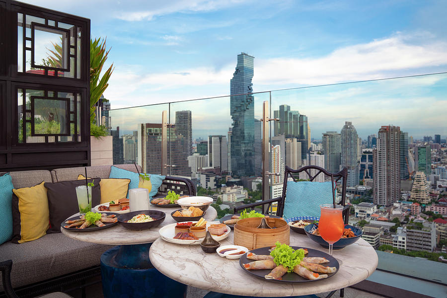 Table of chinese food on the table in roof top bar Photograph by Anek ...