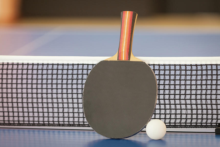 Table Tennis Or Ping Pong Racket And Ball On Blue Table, Net Photograph
