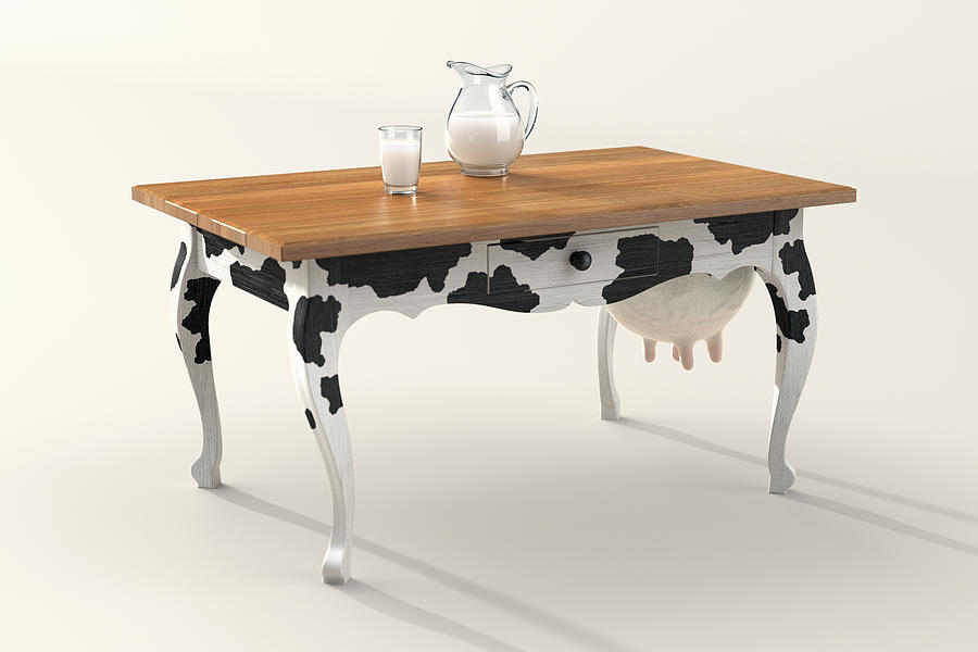 Table with cow print and udder, milk in carafe Photograph by Dieter Spannknebel