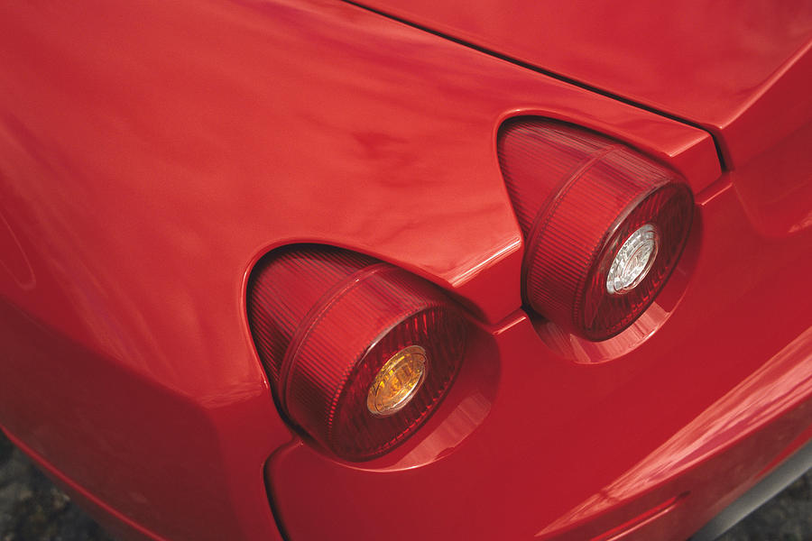 Tail lights on a red sports car Photograph by Aron Jungermann