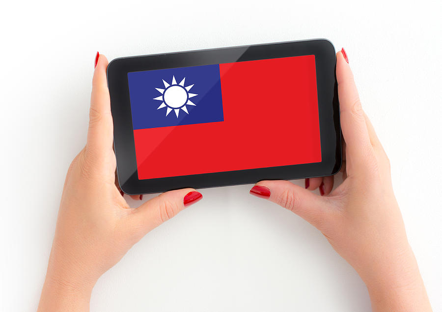 Taiwanese Flag on digital tablet in mature female hand with Personal Perspective Photograph by Beeldbewerking