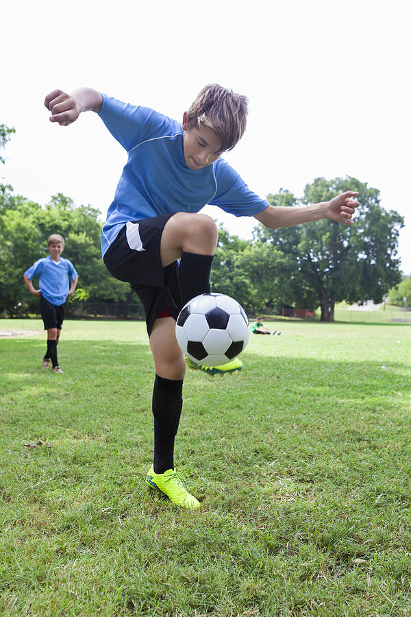 Talented soccer player performs tricks with the ball Photograph by SDI Productions