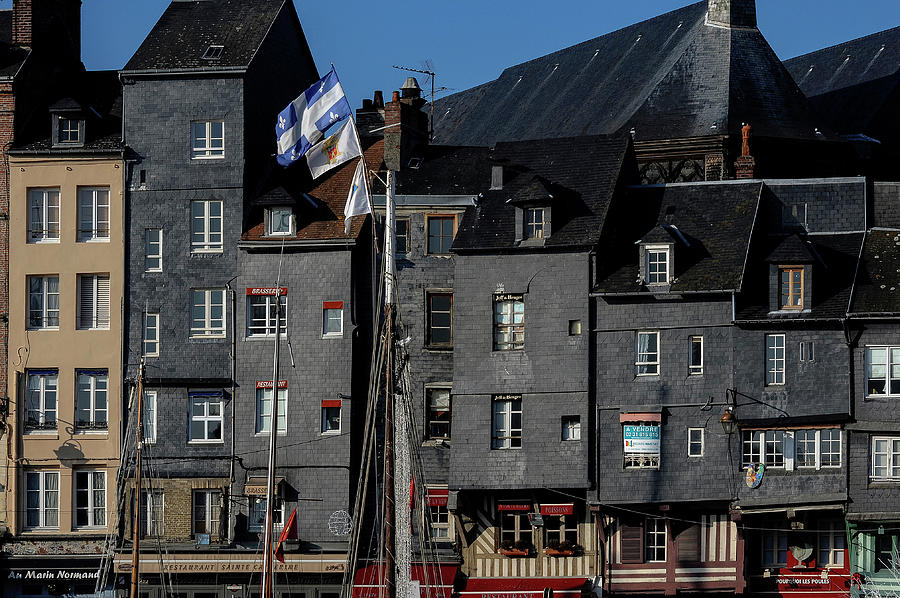 Tall and narrow townhouses, restaurants and brasseries on Quai Sainte