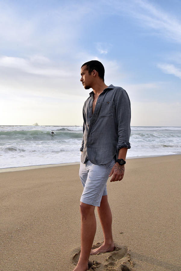 Tall slender young man standing on the beach stock photo Photograph by Mark Stout