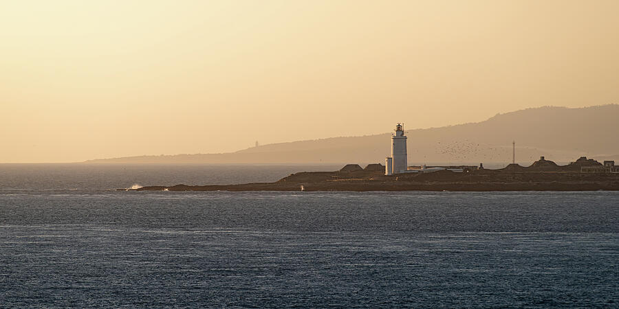 Tarifa Lighthouse on the Isla de las Palomas at Sunse Photograph by ...