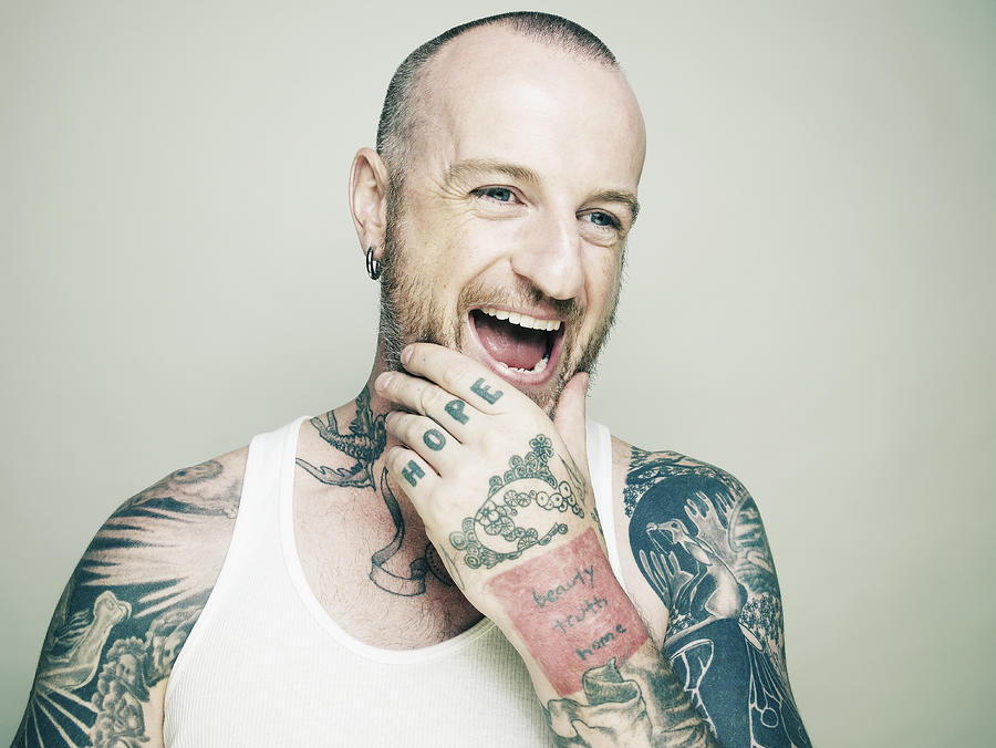 Tattooed man laughing. Photograph by Ballyscanlon