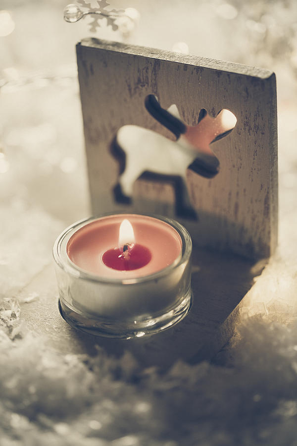 Tea light holder with lightened red candle on artificial snow Photograph by Westend61