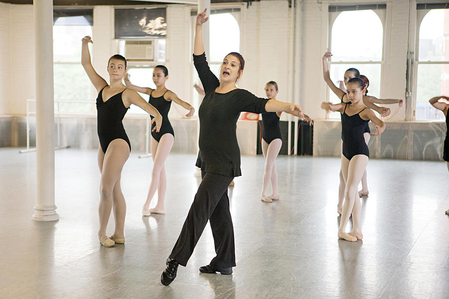 Teacher and ballet dancers Photograph by Image Source