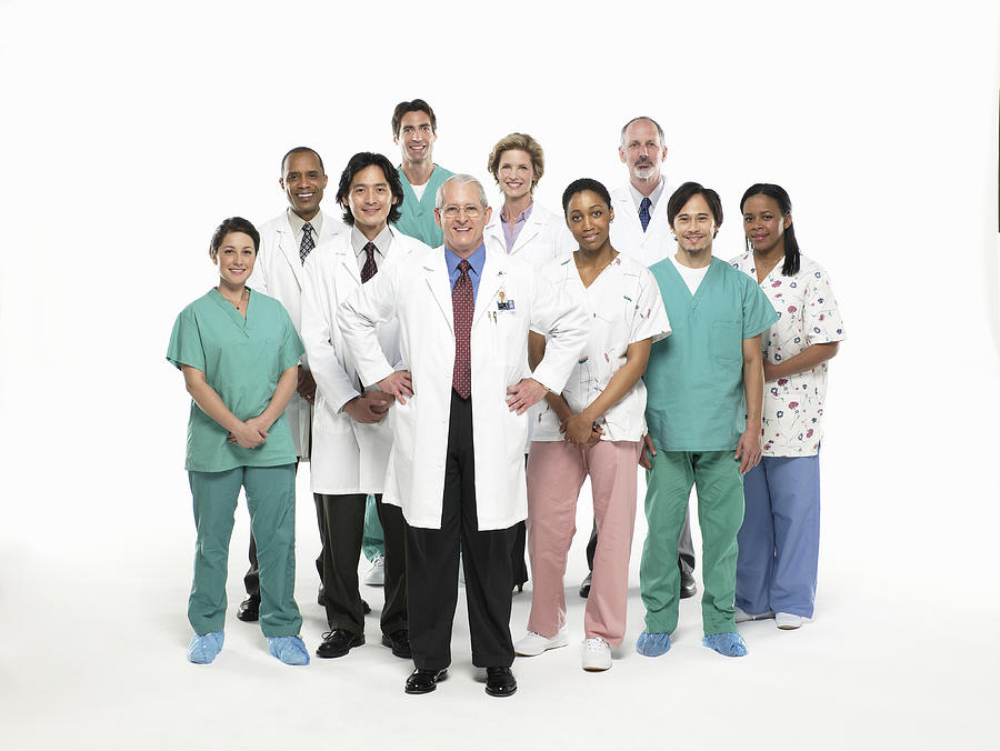 Team of doctors, nurses and surgeons standing on white background, portrait Photograph by Siri Stafford