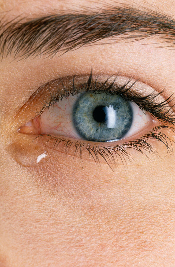 Tear in womans eye Photograph by Jupiterimages