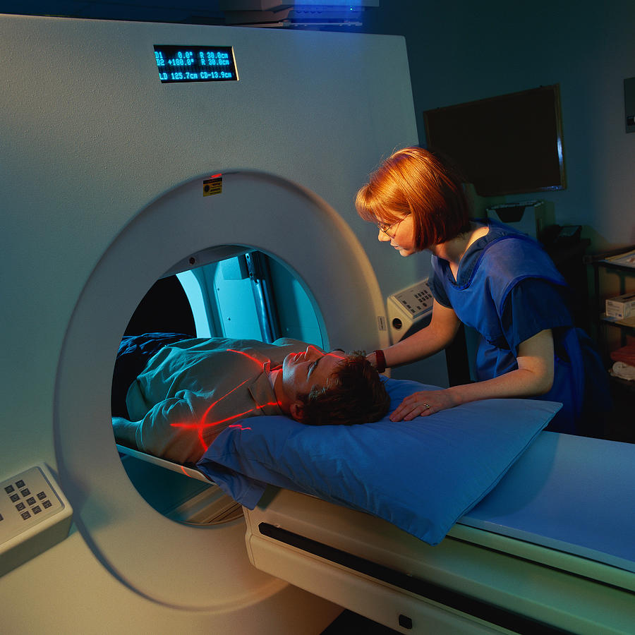 Technician giving man CAT scan Photograph by Stockbyte