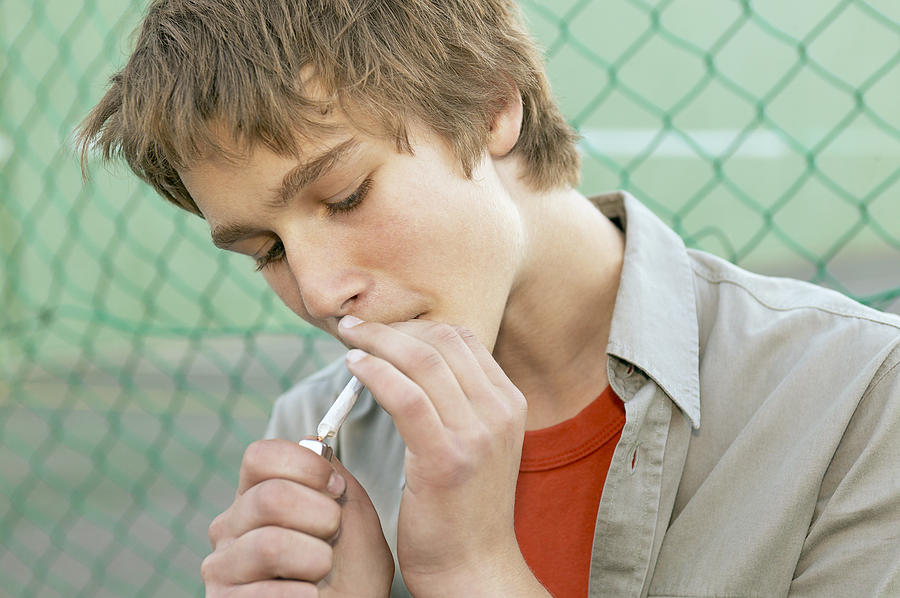 Teen boy smoking Photograph by Tomas Rodriguez