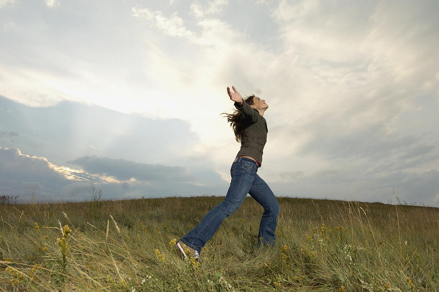 Teen girl dancing in a field Photograph by Beau Lark/Corbis/VCG