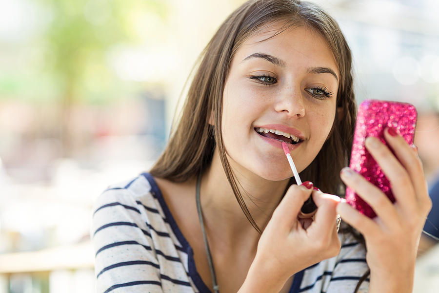 Teen girl fixing her make up Photograph by Mixmike