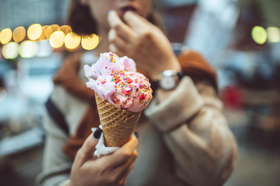 Teen girl with pink eating ice-cream outdoors in summer Photograph by ArtMarie