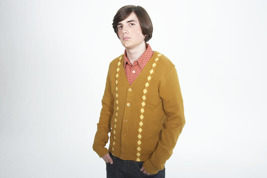 Teenage boy (15-17) with bob haircut, hands in pockets, portrait Photograph by James Woodson