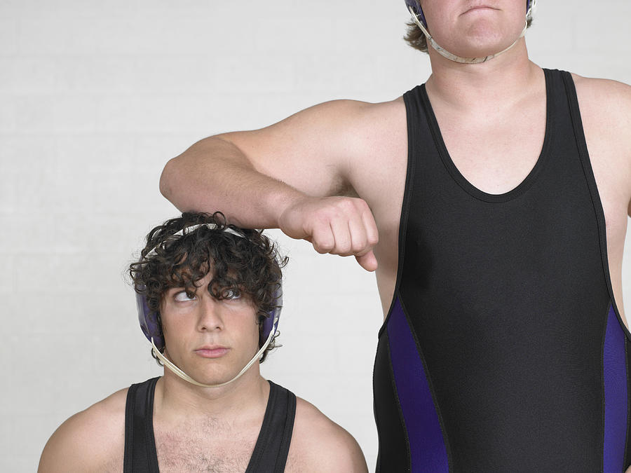 Teenage boys (16-18) wrestler, leaning on short boy Photograph by Sean Justice