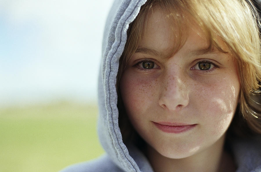 Teenage girl (13-15) wearing hooded sweatshirt, close-up, portrait Photograph by Vicky Kasala Productions