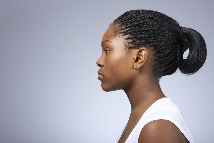 Teenage girl (15-17) with hair tied back, close-up, profile Photograph by James Woodson