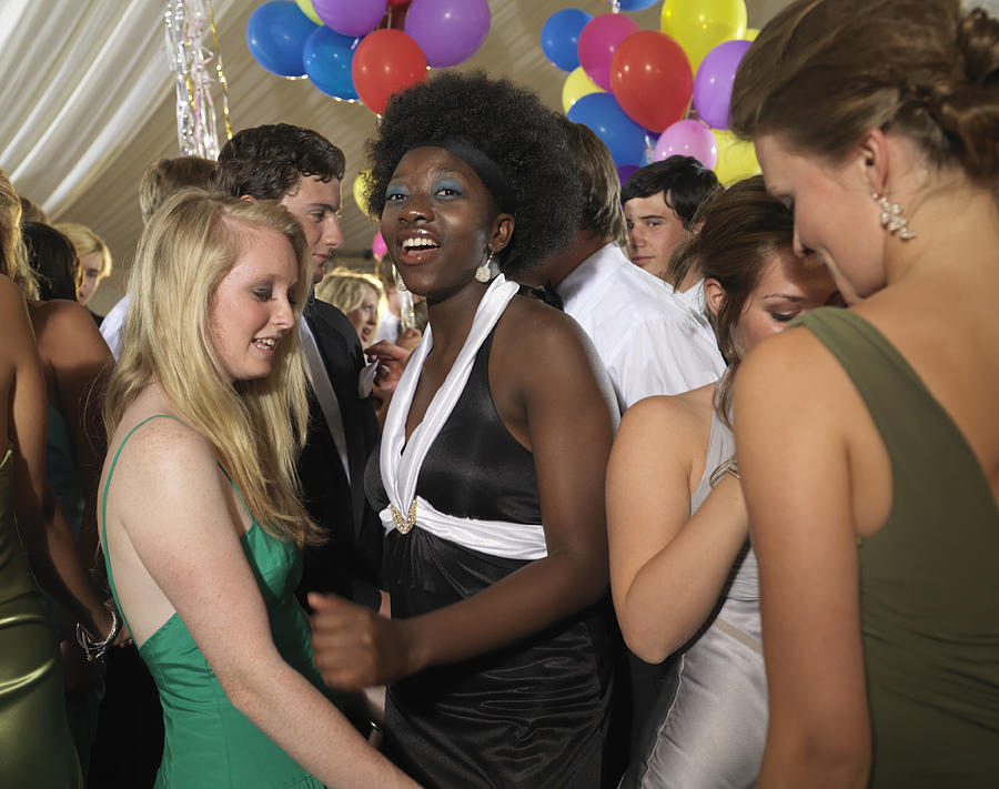 Teenage girl (16-17) with young women dancing in party Photograph by Bob Thomas